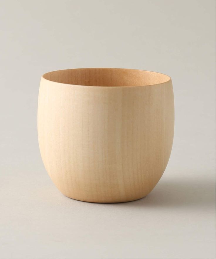 a wooden bowl sitting on top of a table