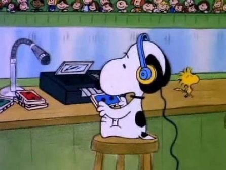 a cartoon dog with headphones sitting at a desk