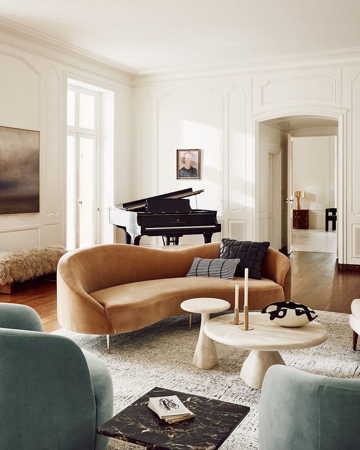 a living room filled with furniture and a piano