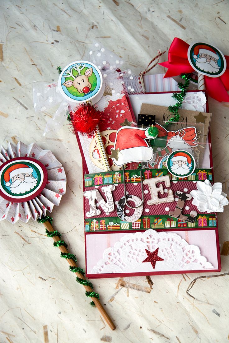 a close up of a greeting card on a table with decorations and paper items around it