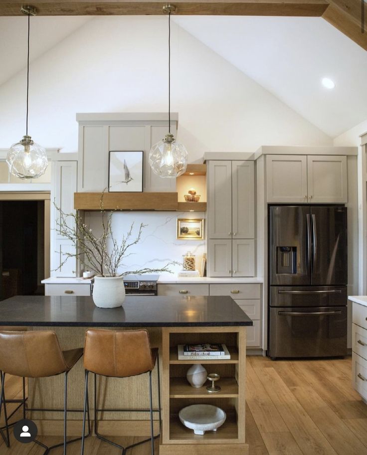 a kitchen with two stools and an island