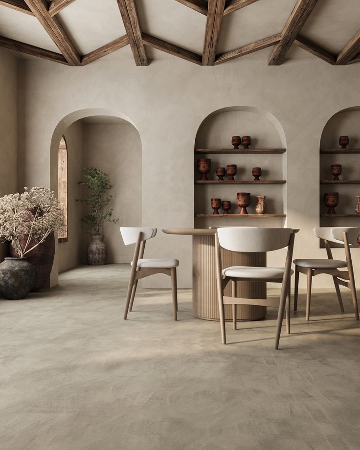 a dining room with tables, chairs and vases on the shelves next to each other