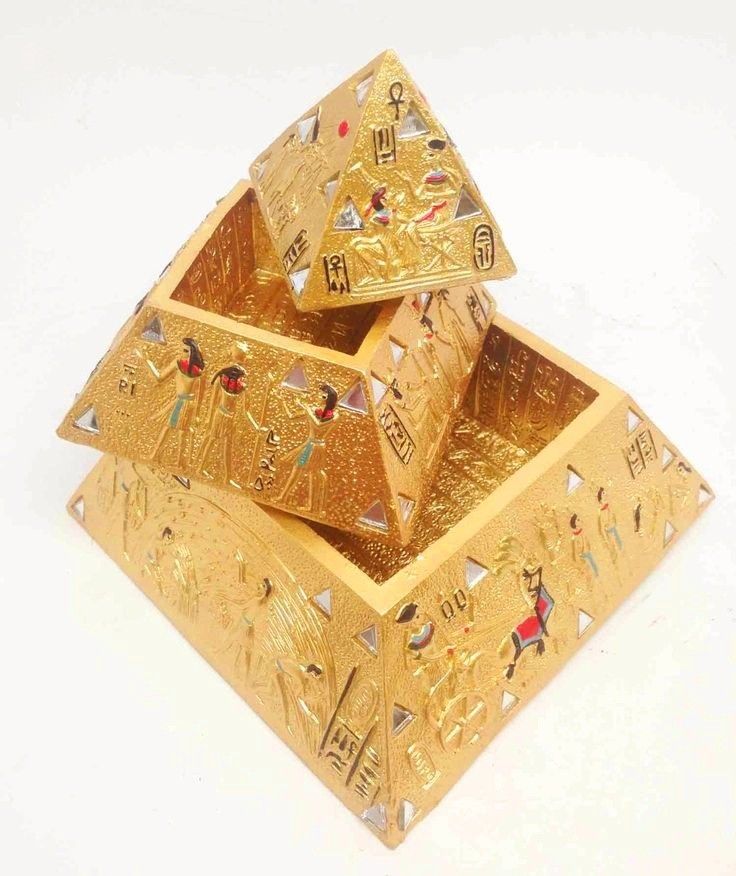 two gold boxes with egyptian designs on them