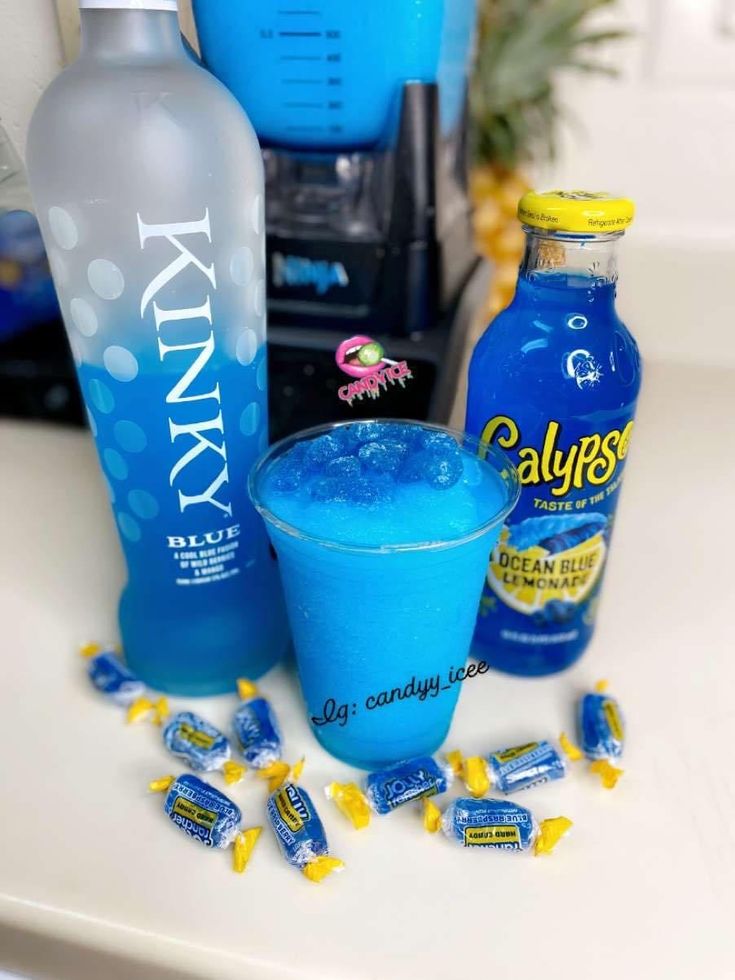 blue drinks and candy are sitting on the counter