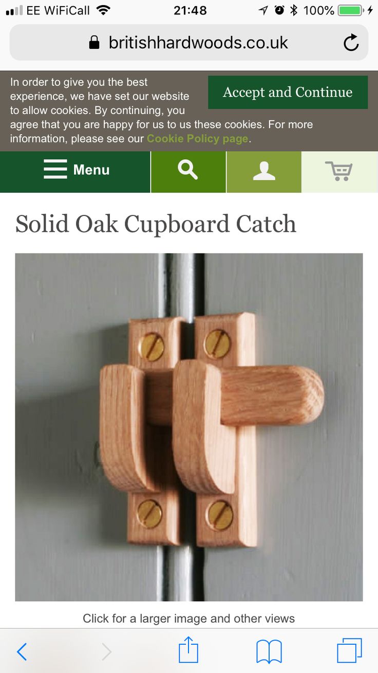 an image of a wooden latch on a door with the words solid oak cupboard catch