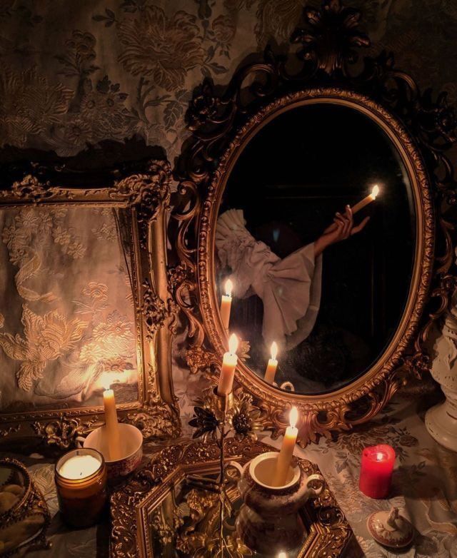 a mirror that has some candles in front of it