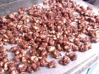 there are many pieces of chocolate popcorn on the counter top, ready to be eaten