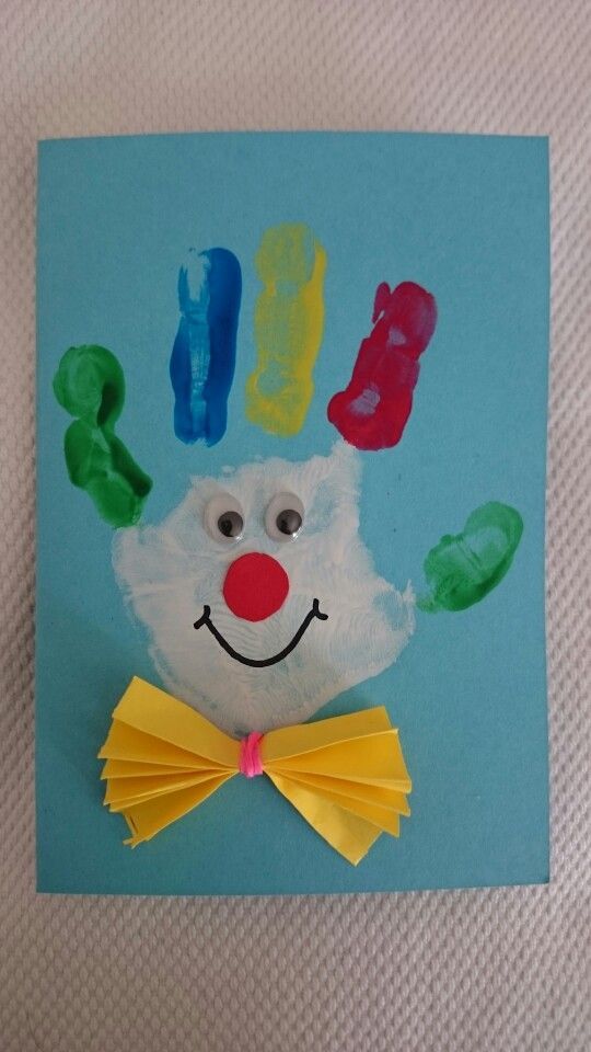 a paper plate with a hand and feet made to look like a clown