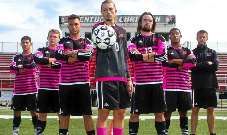 a group of soccer players standing on top of a field with their arms around each other