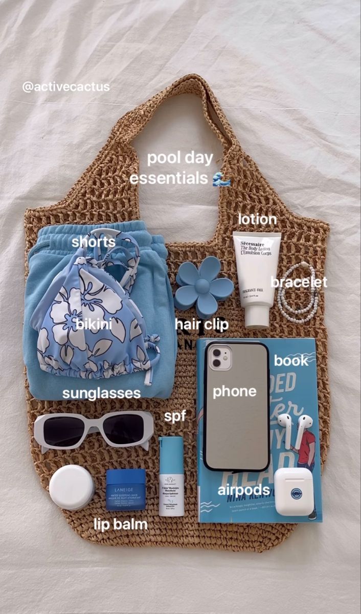 the contents of a purse laid out on top of a white sheet with words describing what's in it