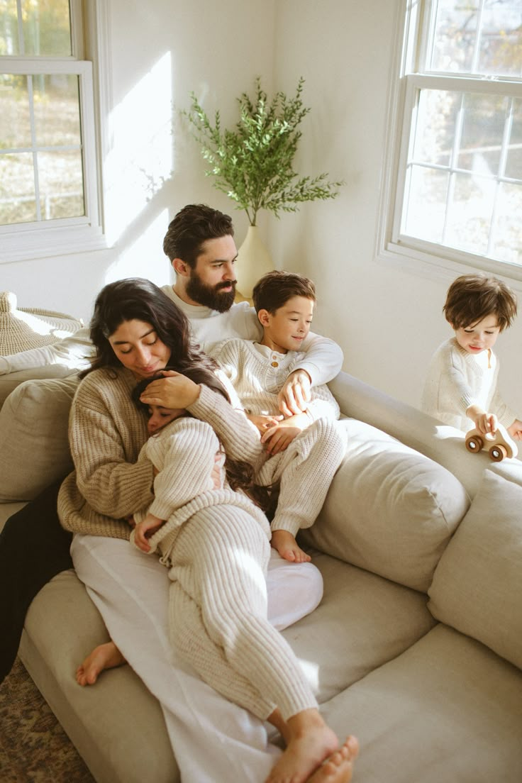 a family sitting on a couch in pajamas