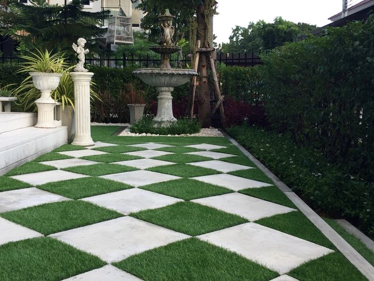 an artificial grass lawn with white and black checkerboard pattern