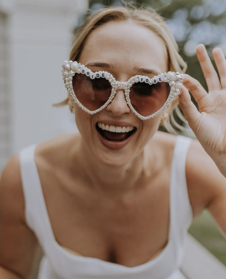 a woman wearing sunglasses with pearls on them