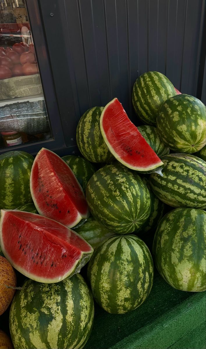 a pile of watermelons sitting on top of each other