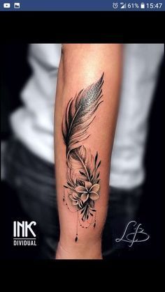 a black and white photo of a feather with flowers on it's arm, done by