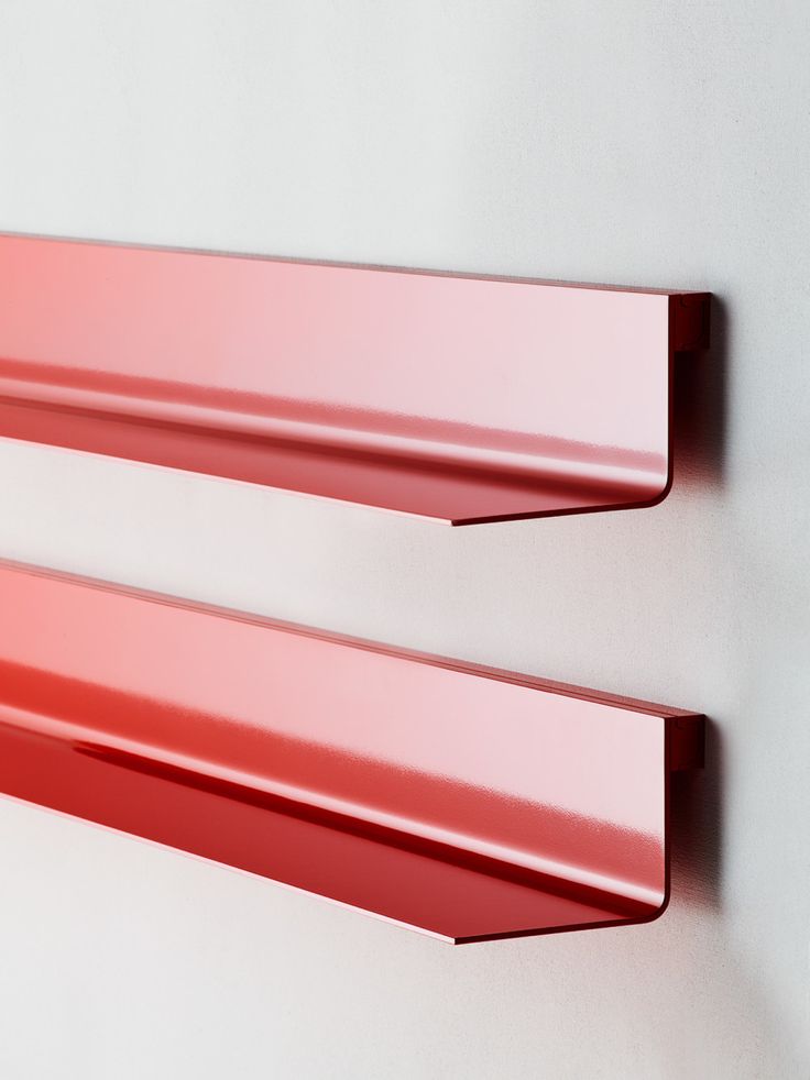 two red metal shelfs mounted to the wall