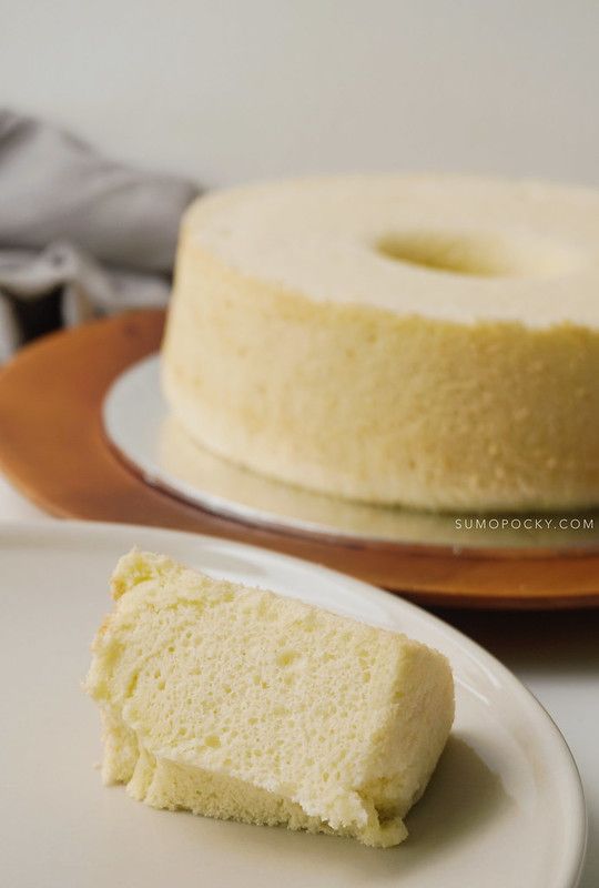 a piece of cake sitting on top of a white plate next to a bundt cake