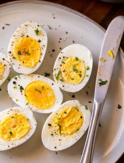 hard boiled eggs on a plate with a knife and fork