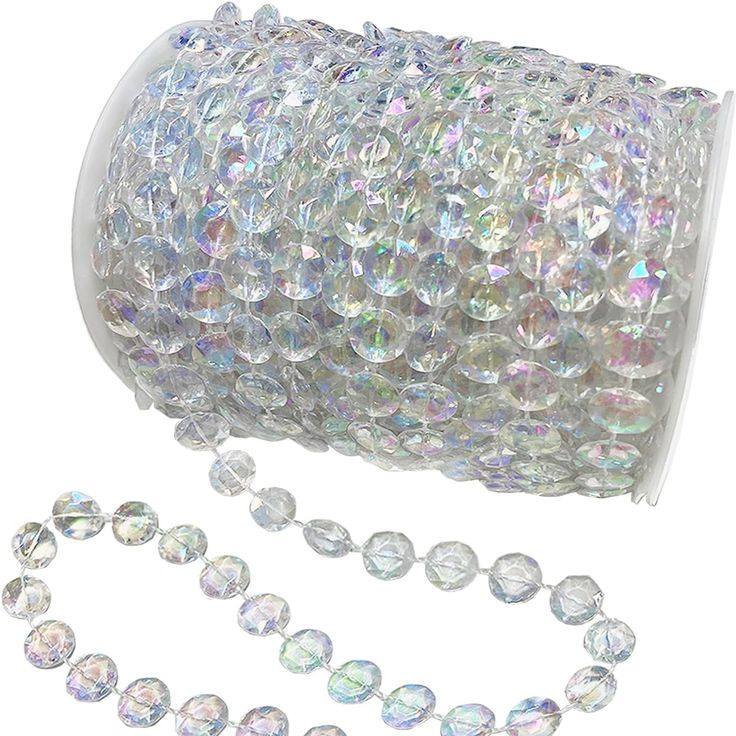 a roll of clear beaded glass beads on a white background with a chain attached to it