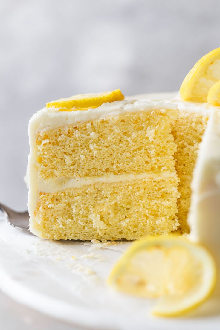 a slice of lemon cake on a plate with a fork