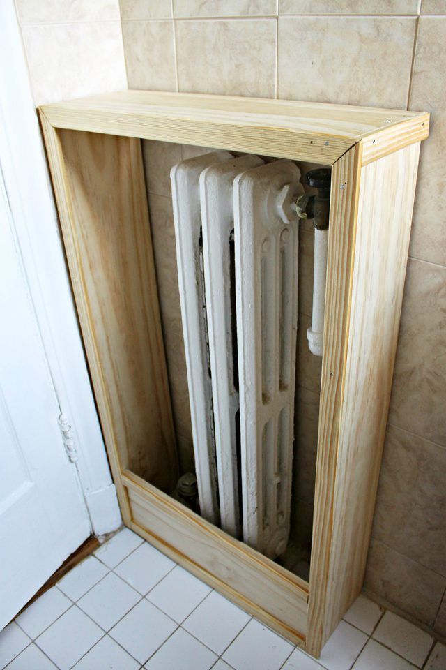 a wooden cabinet with three radiators in it