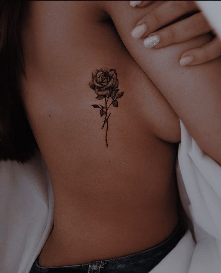 a woman with a rose tattoo on her chest