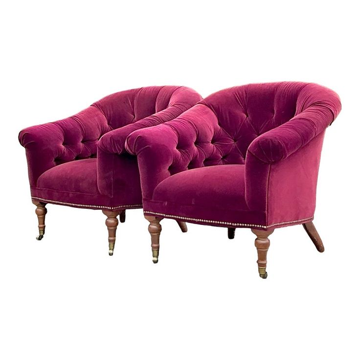 two pink velvet chairs with wooden legs