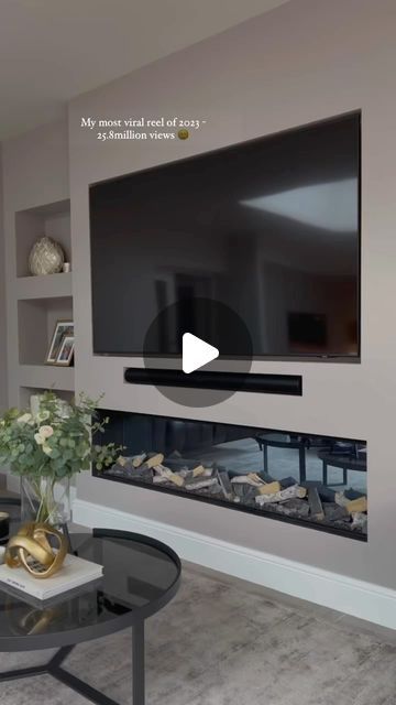 a large flat screen tv mounted to the side of a wall in a living room