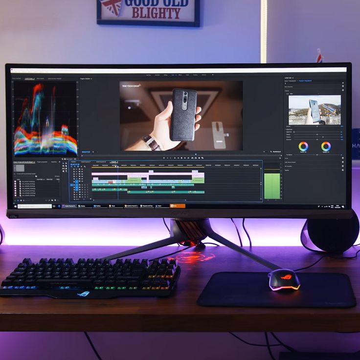 a computer monitor sitting on top of a wooden desk next to a keyboard and mouse