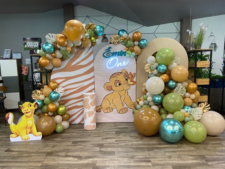 the lion king balloon arch is decorated with balloons