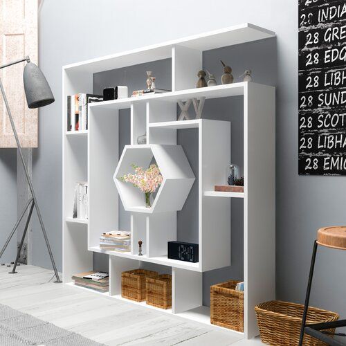 a white book shelf sitting in the corner of a room