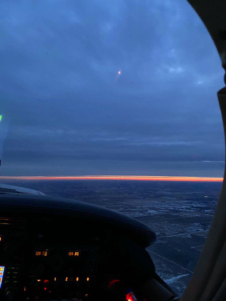 the view from inside an airplane at dusk