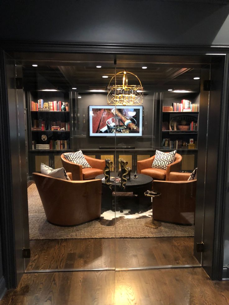 a living room filled with furniture and a flat screen tv mounted to the side of a wall