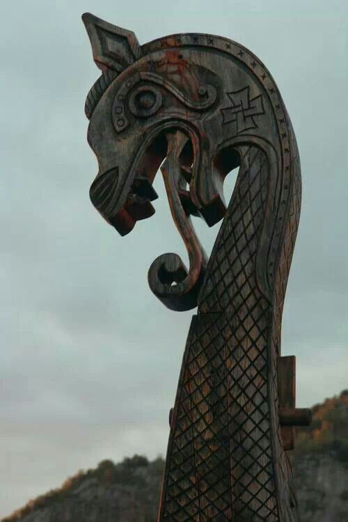 an intricately carved wooden sculpture on top of a hill