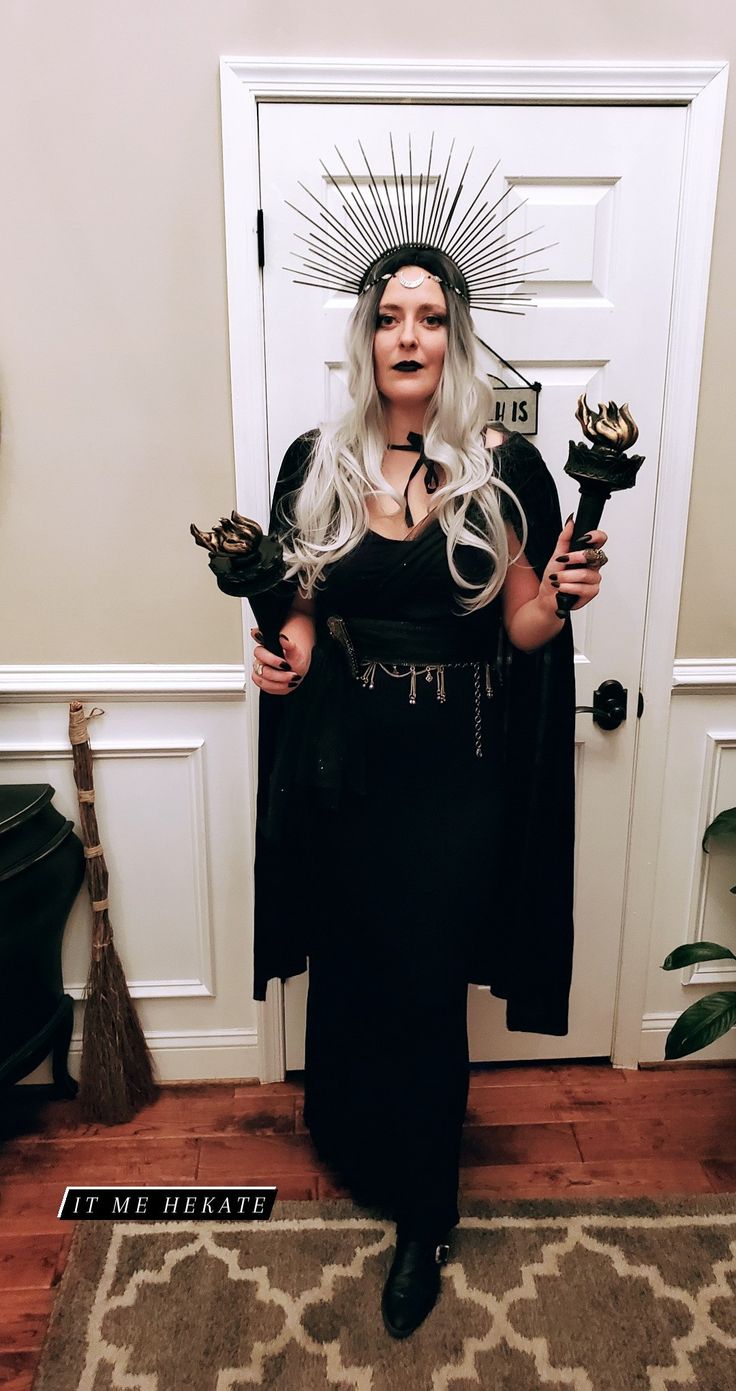 a woman with white hair and black dress holding two wands