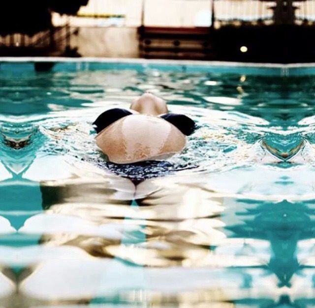 a stuffed animal floating on top of a swimming pool