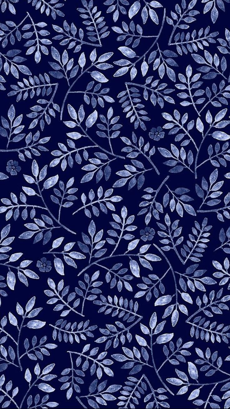 a blue and white leafy pattern on a dark blue background, with small leaves in the center