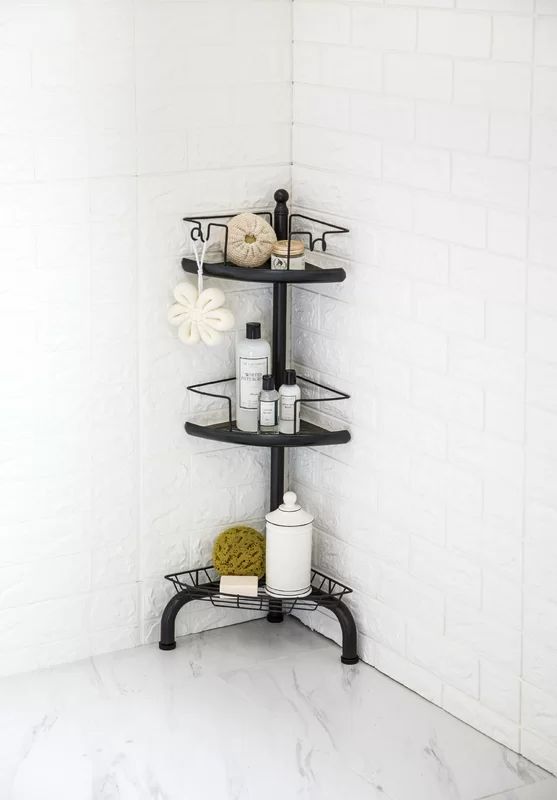 three tiered shelf in the corner of a white tiled bathroom with soap and lotion