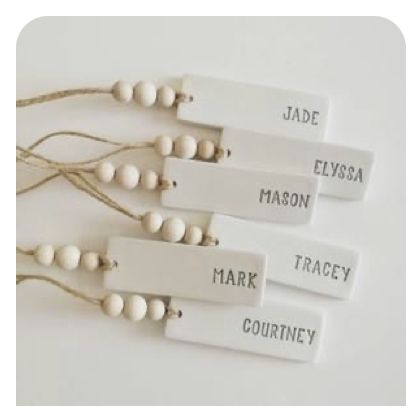 four name tags with string attached to them