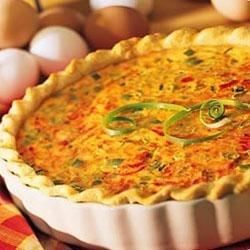 a quiche is shown with eggs in the background