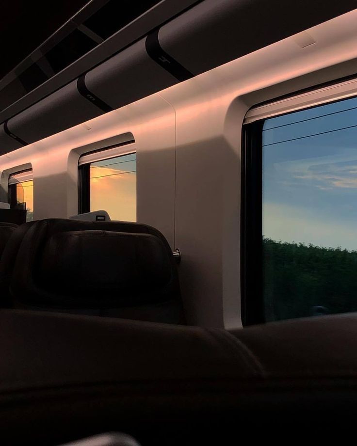 an empty train car with the sun going down