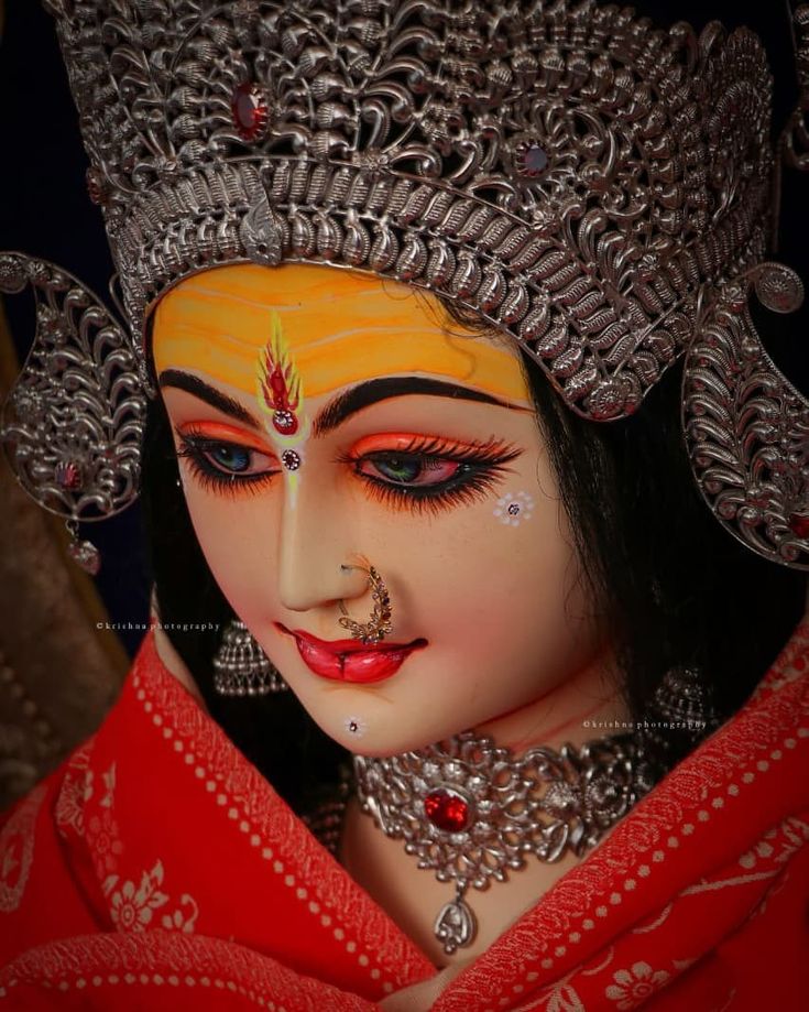 a close up of a person wearing a costume and headpiece with jewelry on it