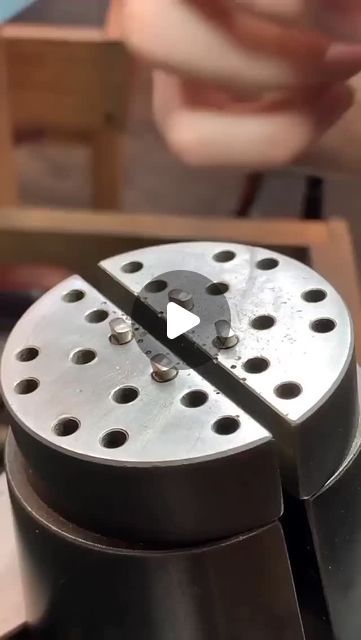 a metal object with holes in the middle and a video playing on it's side