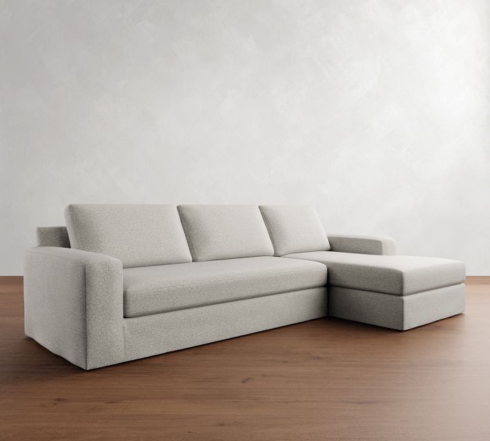 a white couch sitting on top of a wooden floor