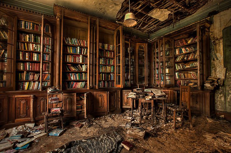 an abandoned library with bookshelves and desks