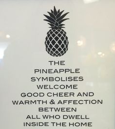 the pineapple symbol is displayed on a sign in front of a door that says,'the pineapple symbolies welcome good cheer and warmth & affection between all who dwell inside the home