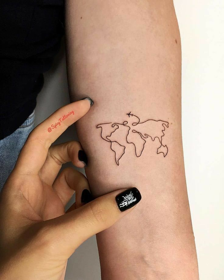 a woman's arm with a small world map tattoo on it