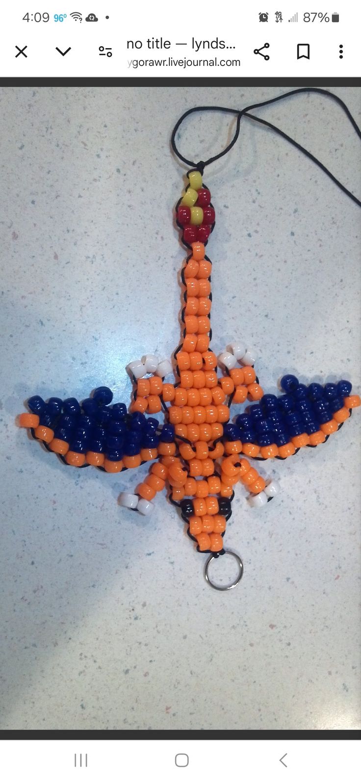 an orange and blue beaded bird ornament