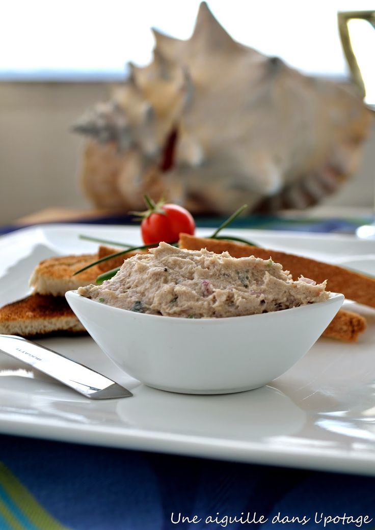 a white bowl filled with food on top of a plate