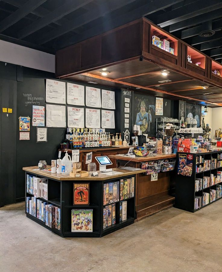 the inside of a liquor store with many items on shelves and posters hanging up against the wall